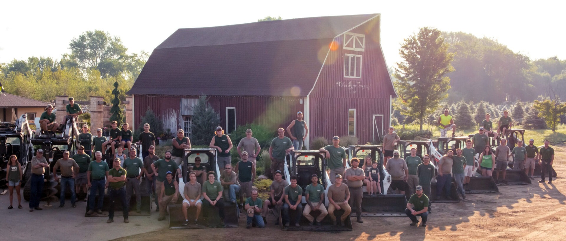 The Willow River team in front of a barn on a sunny day.