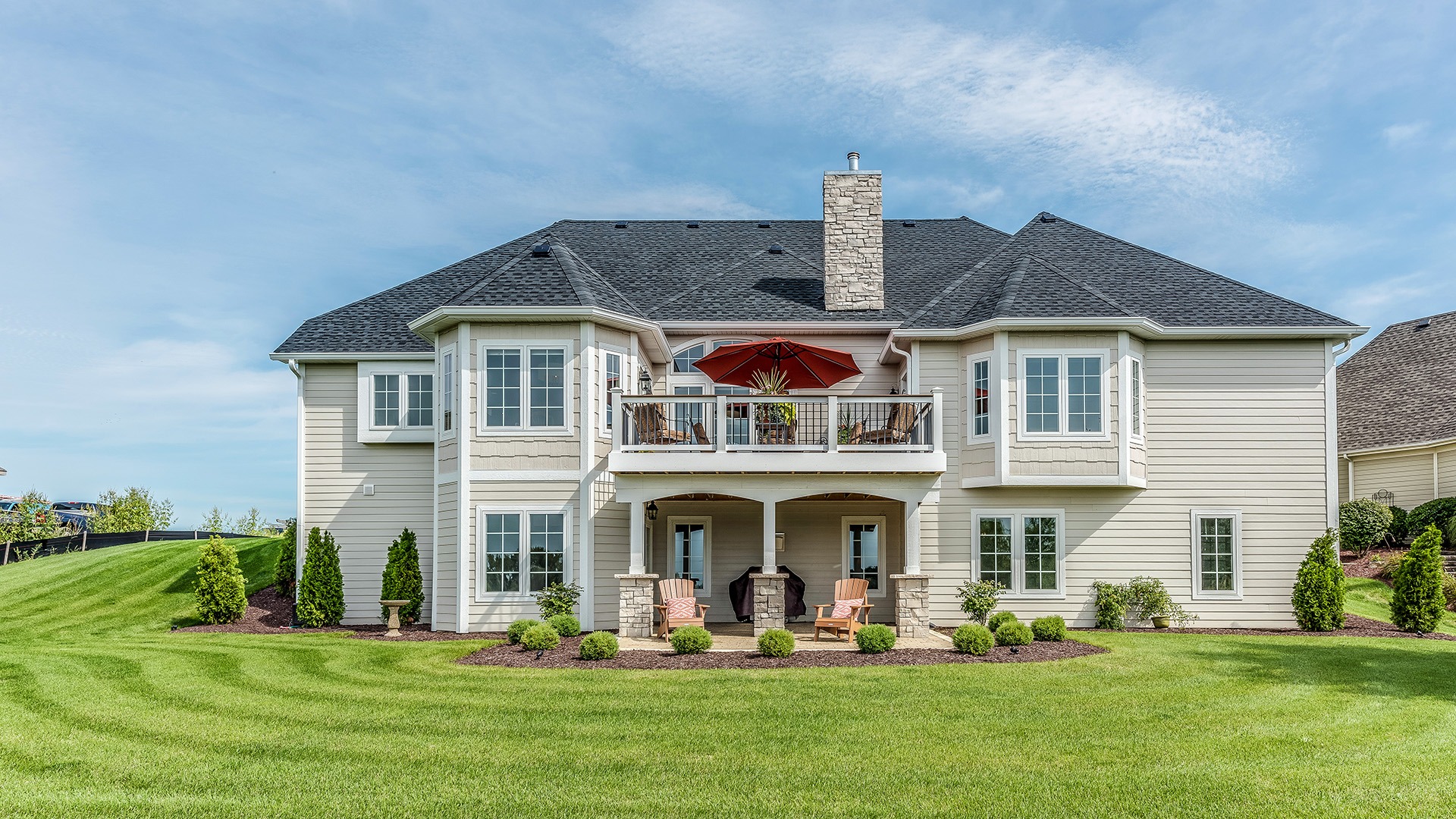 Large home with walk out basement and a deck above