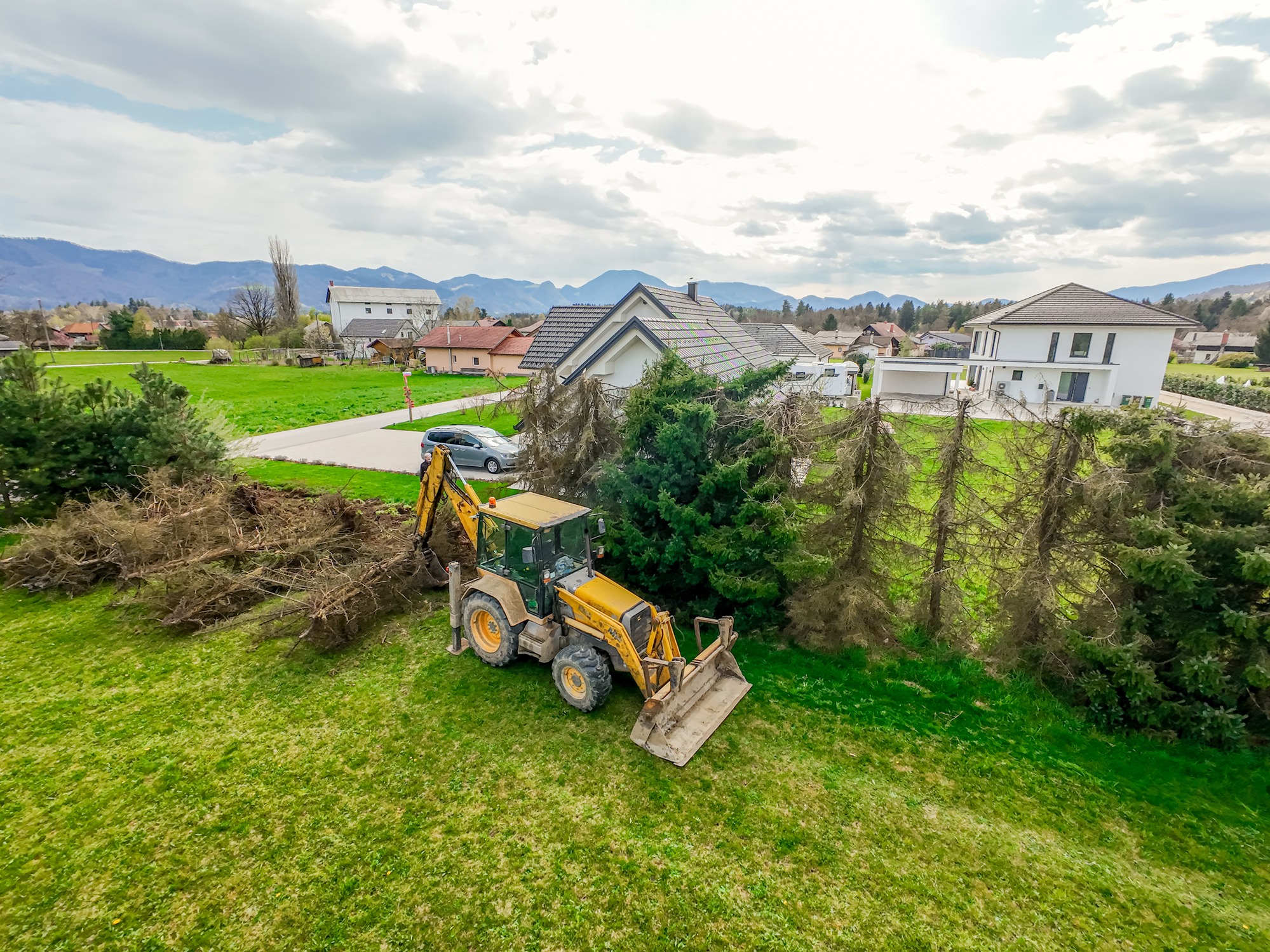 Backhoe Loader Removing Trees, aerial view