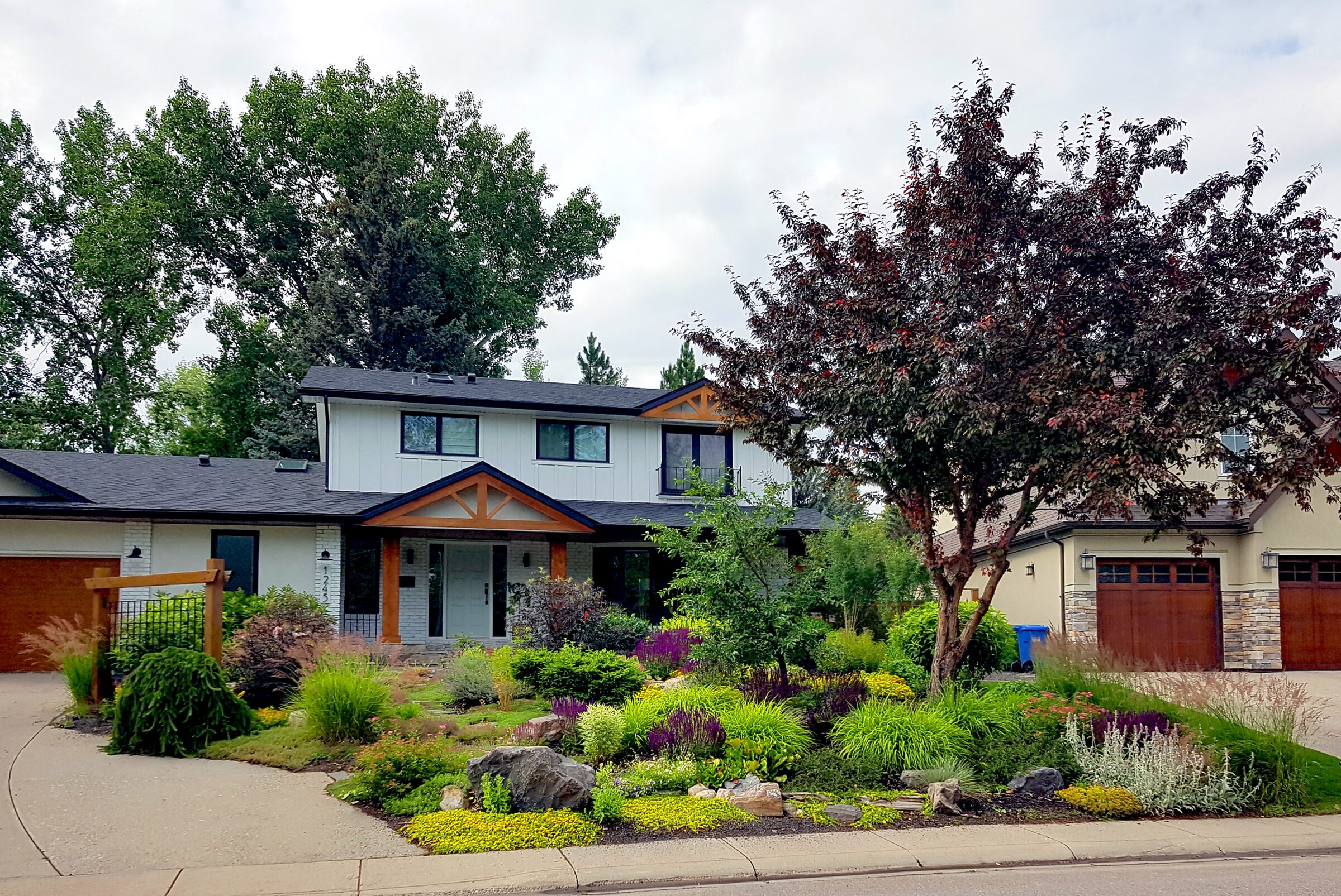A modern home with a lush front yard.