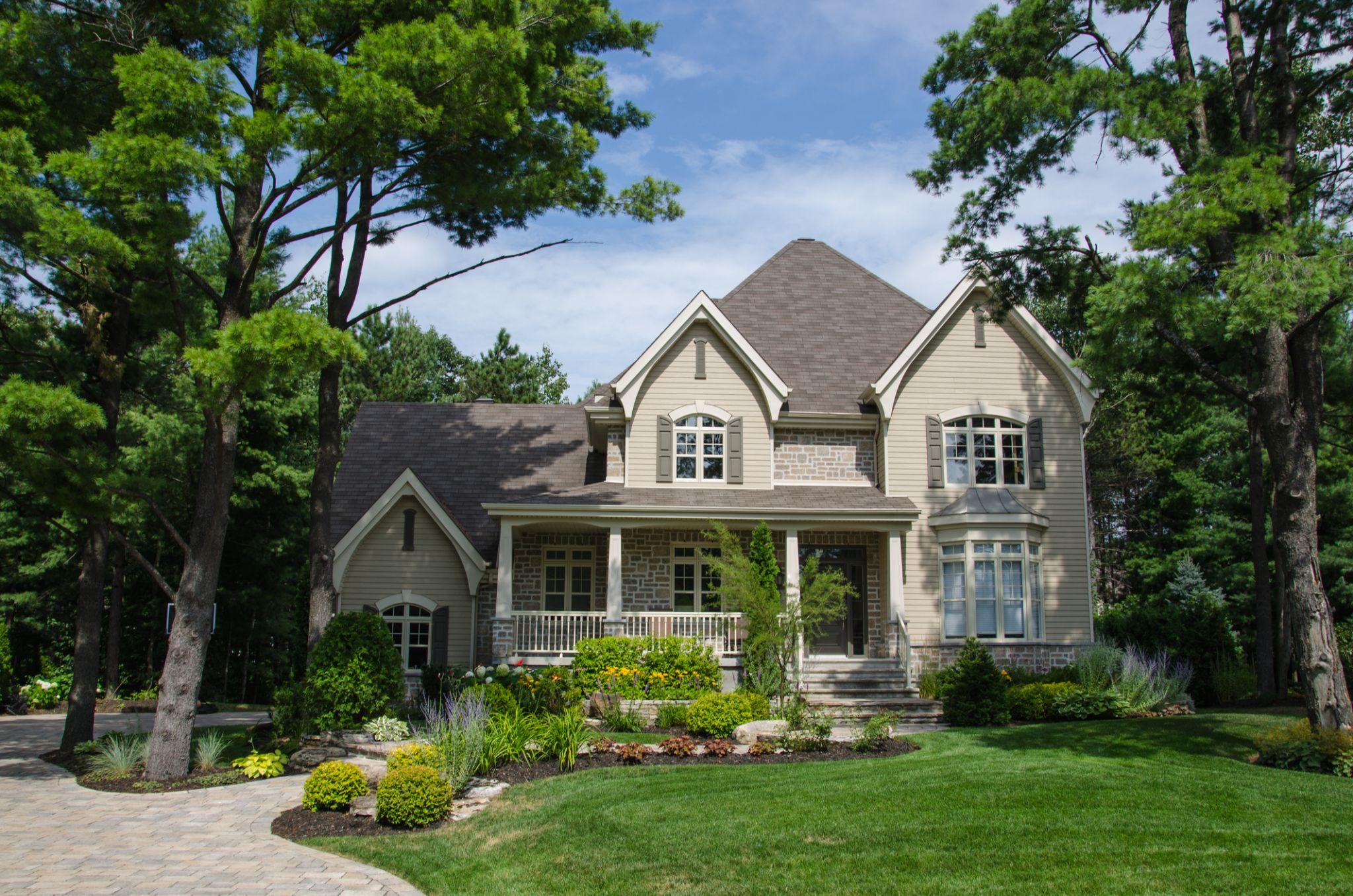 Elegant home with paver driveway and professionally landscaped front yard